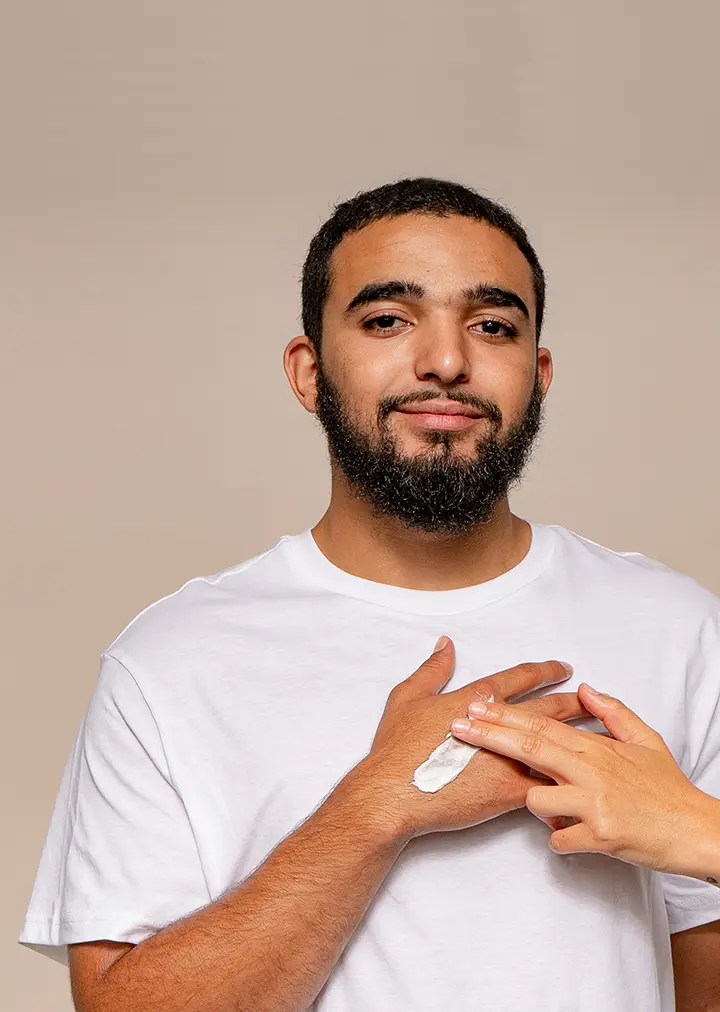 hand applying rebel care handsome handcream to mans hand