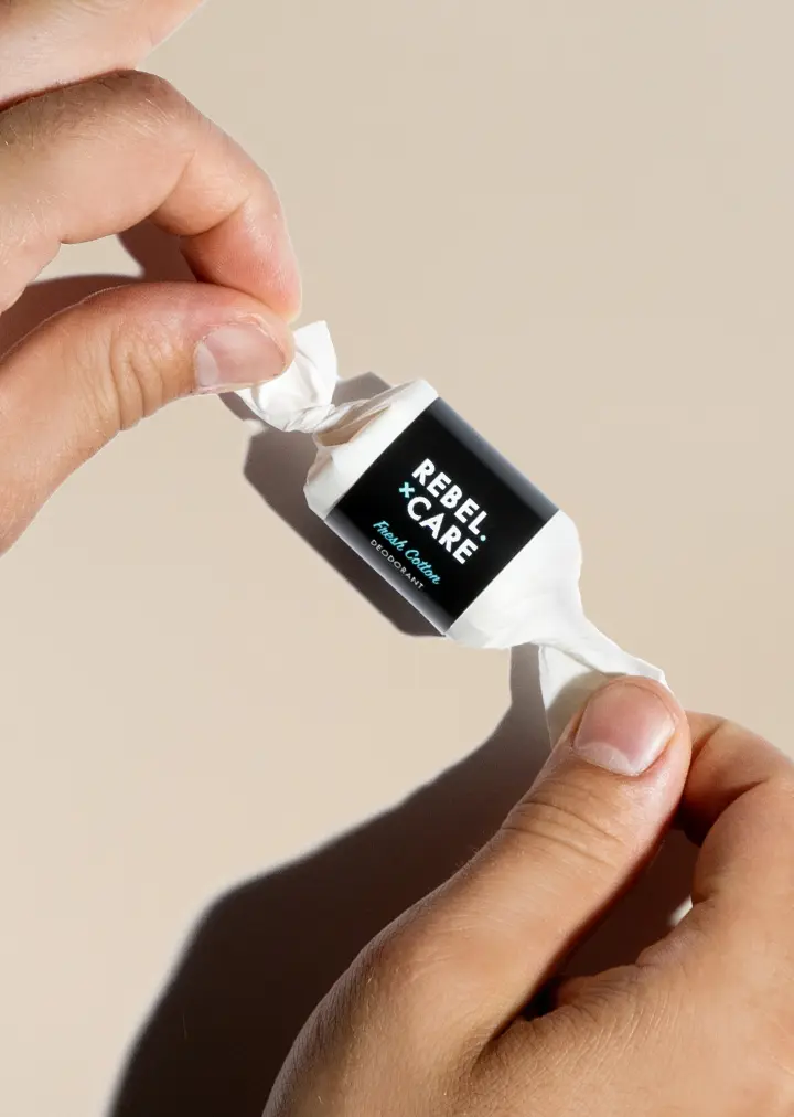 Rebel care fresh cotton deodorant refill with hands unwrapping