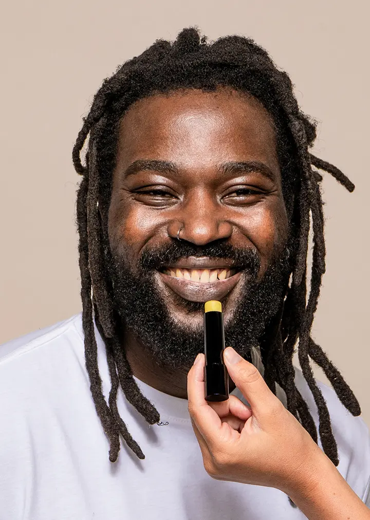 Man applying rebel care Lip balm