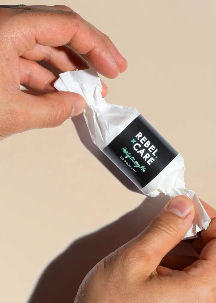 Hands-unwraping-party-in-my-pits-refill Rebel care party in my pits deodorant refill with hands about to unwrap it